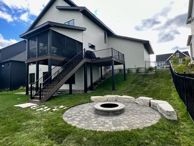 Backyard Landscaping with Stone Patio and Fire Pit image